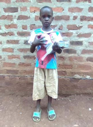 Little Boy Holding Supplies